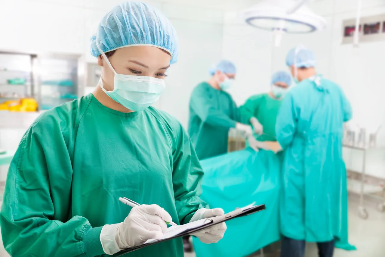 A nurse writing on a clipboard