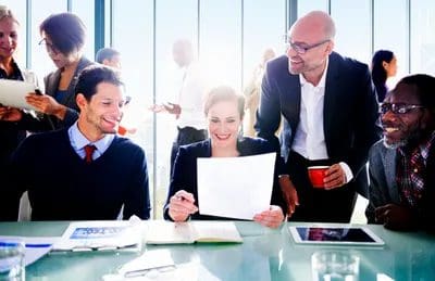 Two seated happy clients viewing a report