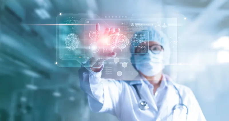 Physician holding a transparent computer screen displaying an image of the brain