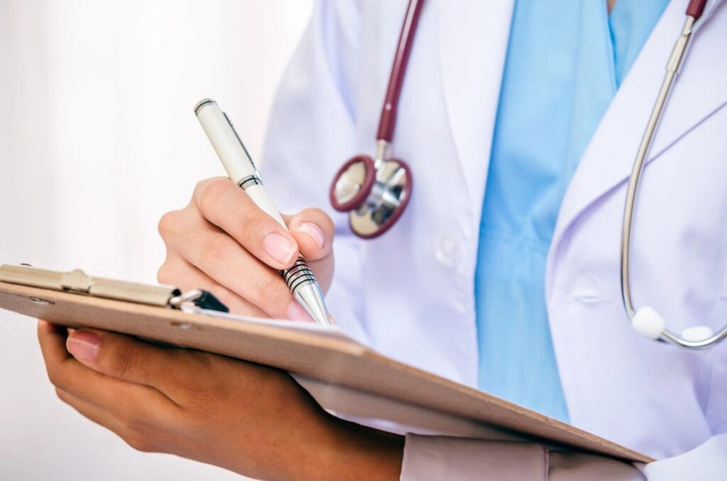 Doctor taking notes on a clipboard