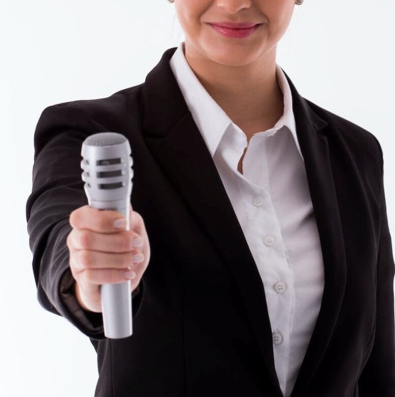 A person holding and mike and offering with a white background