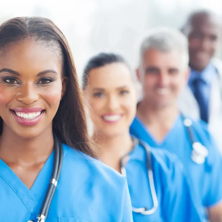 Team of healthcare workers smiling cheerfully